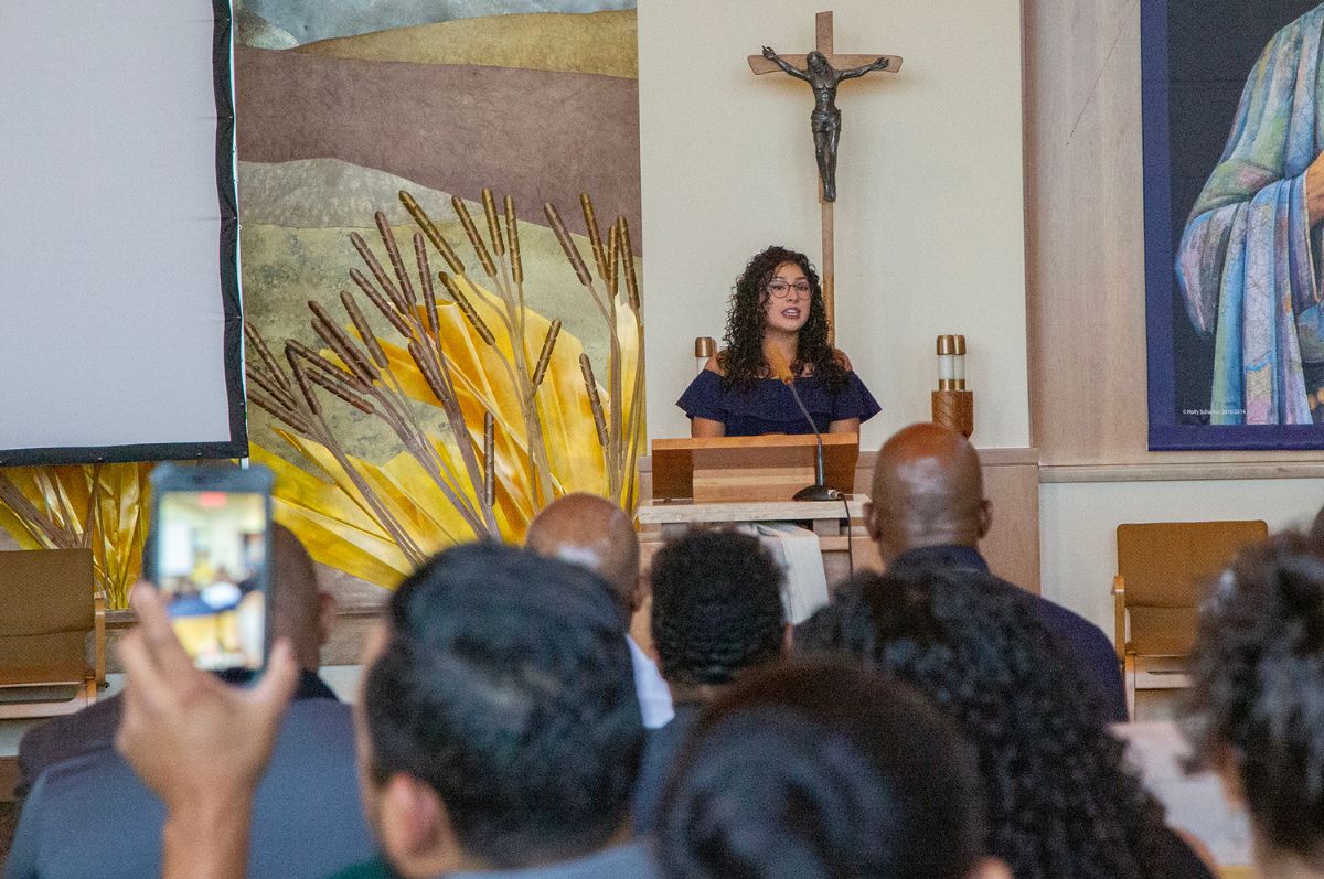 a graduate speaks to a crowd