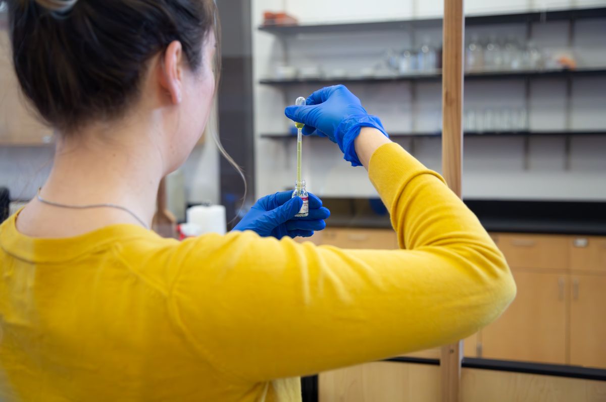Student using a pipette to distill medication