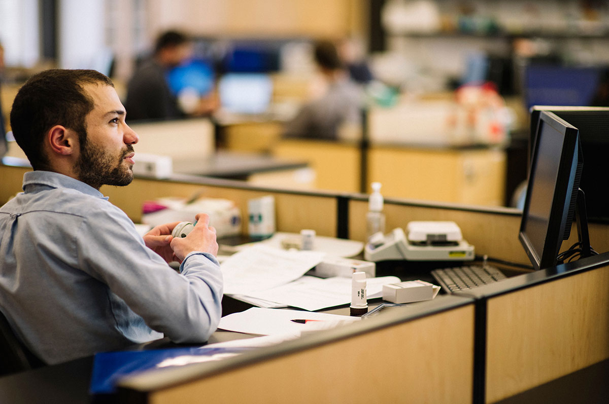 professional man sits at a desk in a medical office