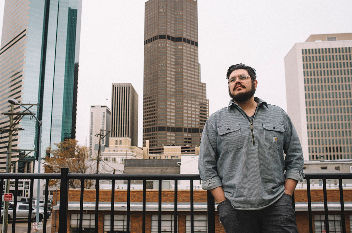 Clayton Gonzales, a two-time Regis graduate overlooks Downtown Denver
