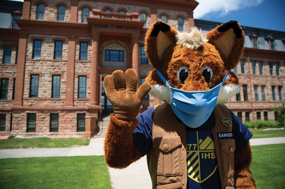 Regi wears a mask in front of Main Hall