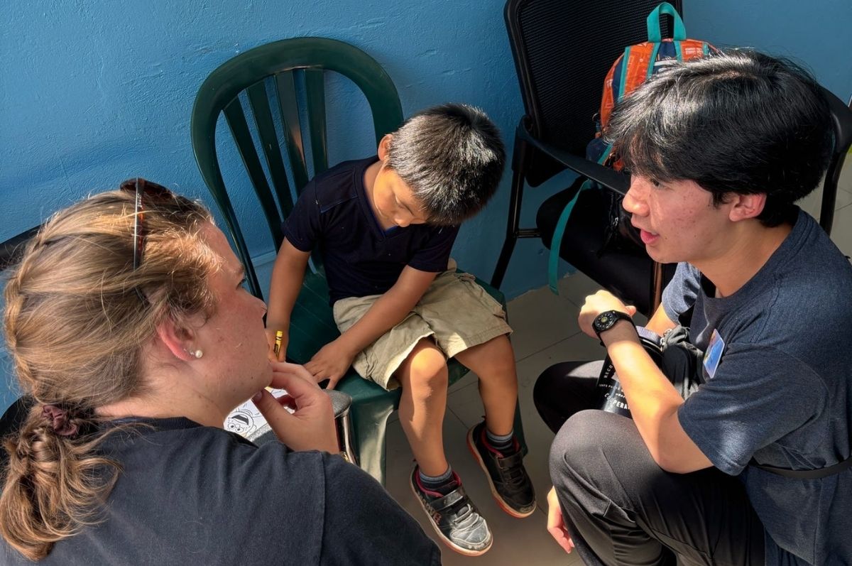 Two students helping with a child patient