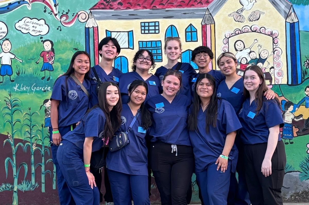 Regis students posed in front of La Ciudad de la Esperanza