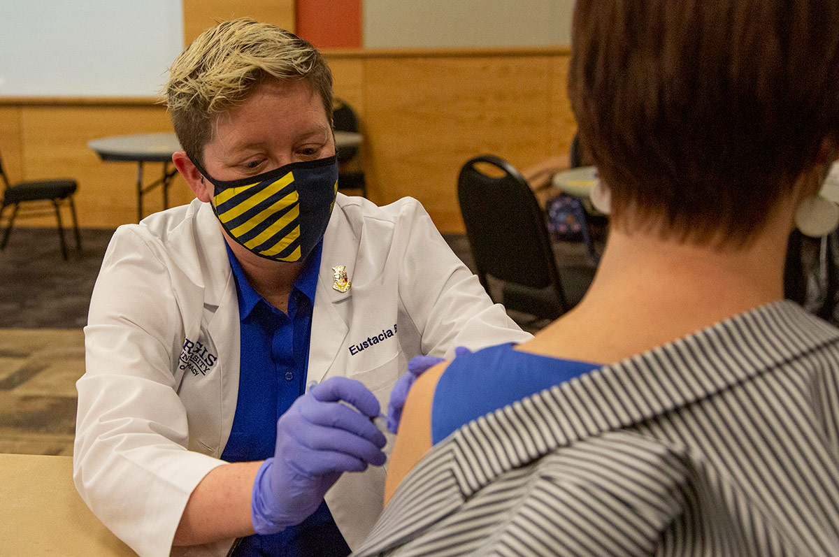 Receiving vaccine shot at Regis university
