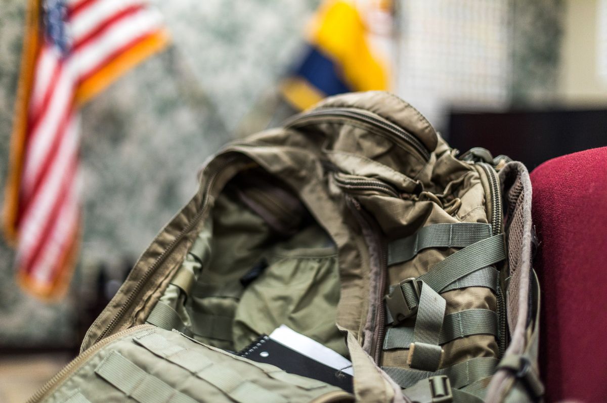 Military backpack in front of American flag at Regis