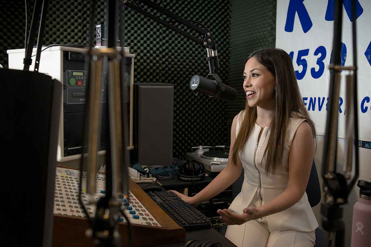 female speaking into microphone in studio