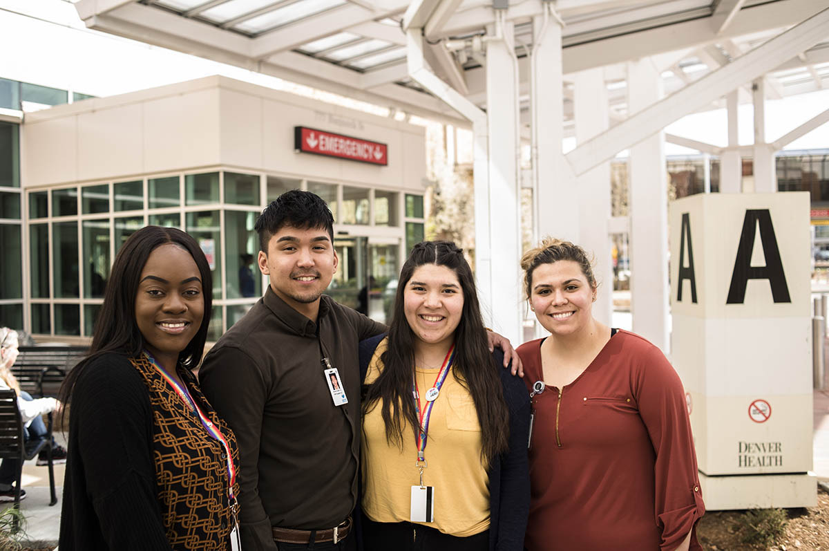 students posing in front of denver health