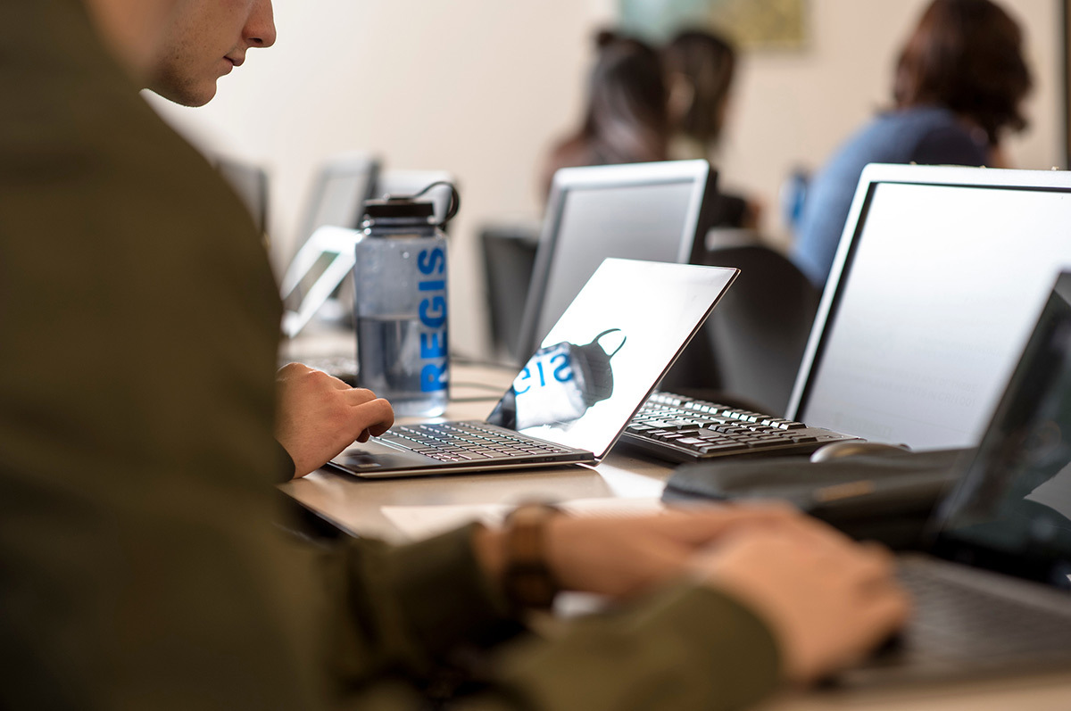 Students using their laptops to compete in the Rocky Mountain Collegiate Cyber Defence Competition hosted by Regis University