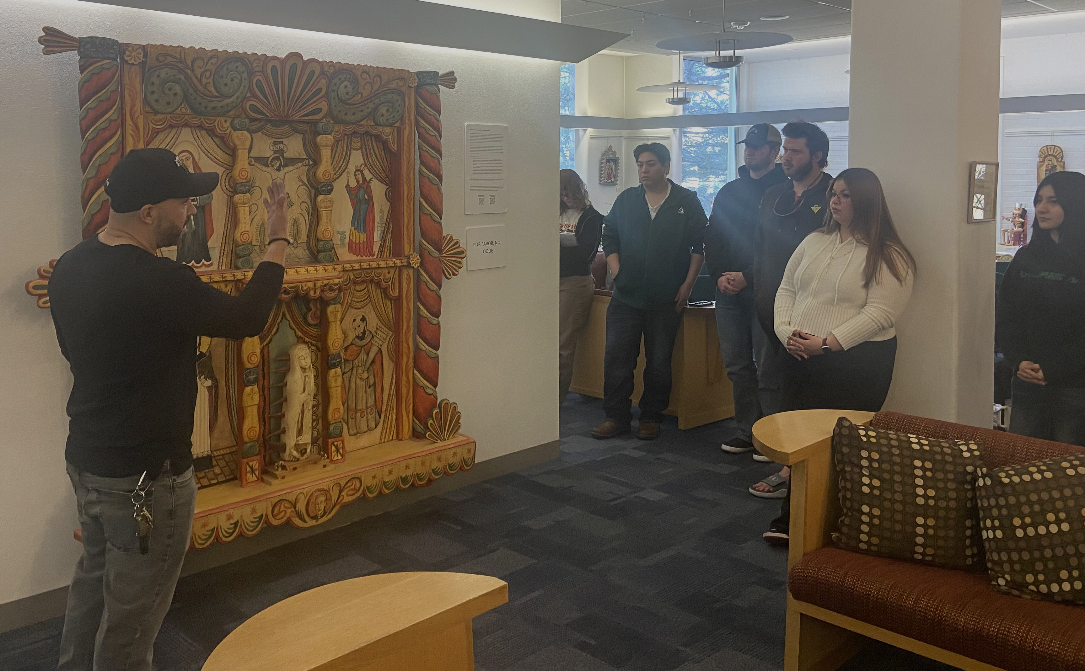 Santero Sean Trujillo explaining the process of his work.