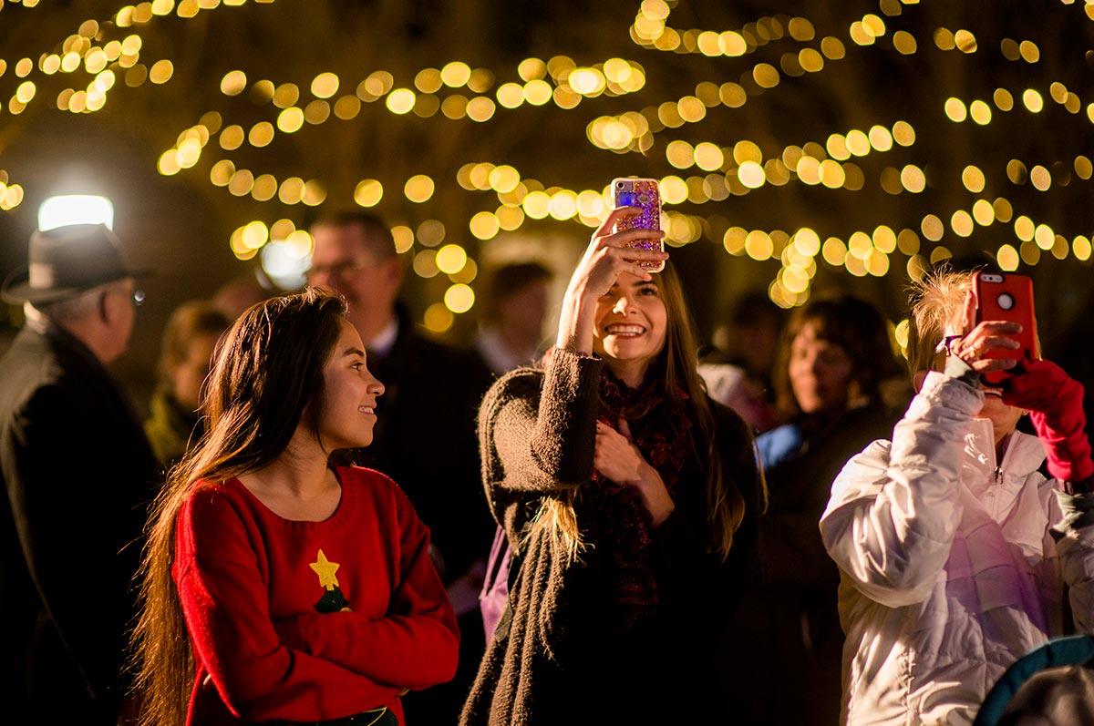 Regis University students enjoying the holiday lights on campus