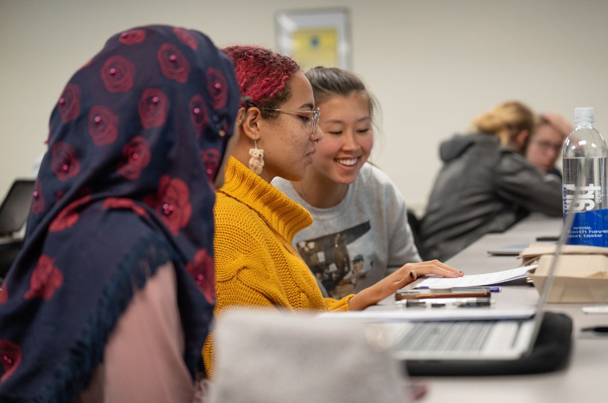 students talk in classroom at Regis