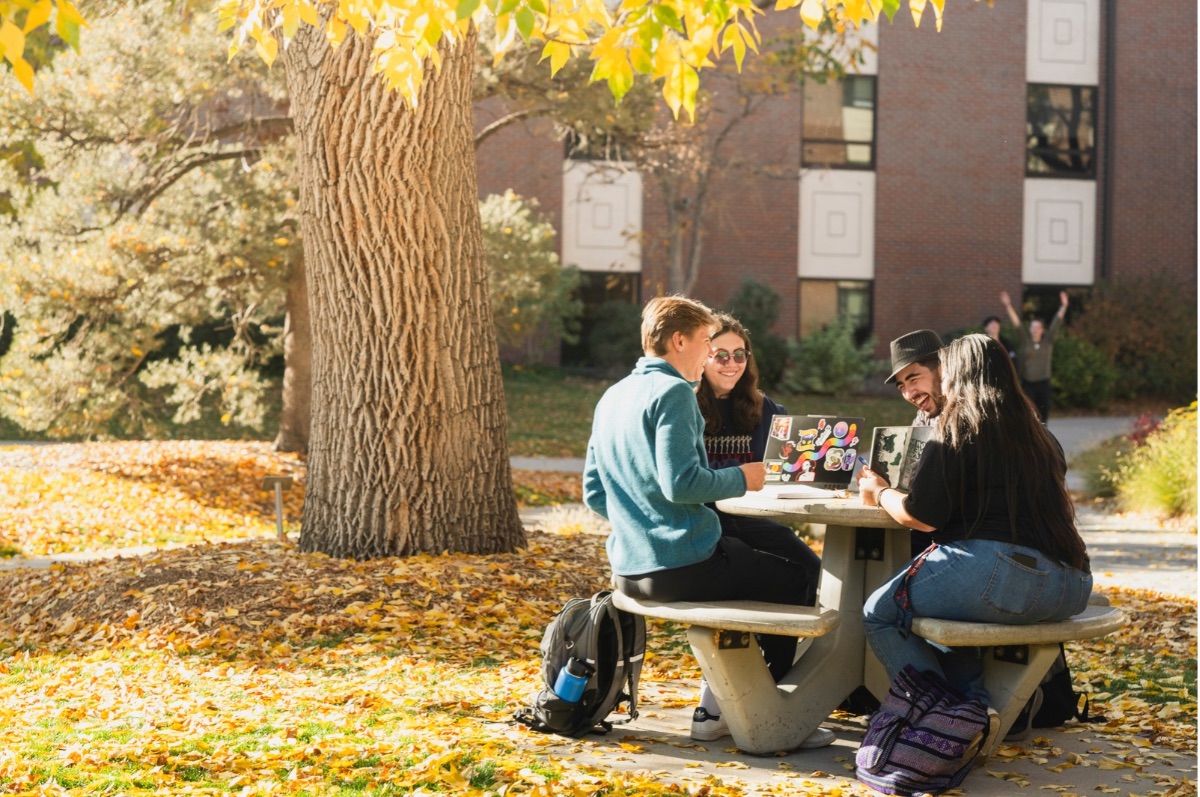 Students sitting at a table on campus