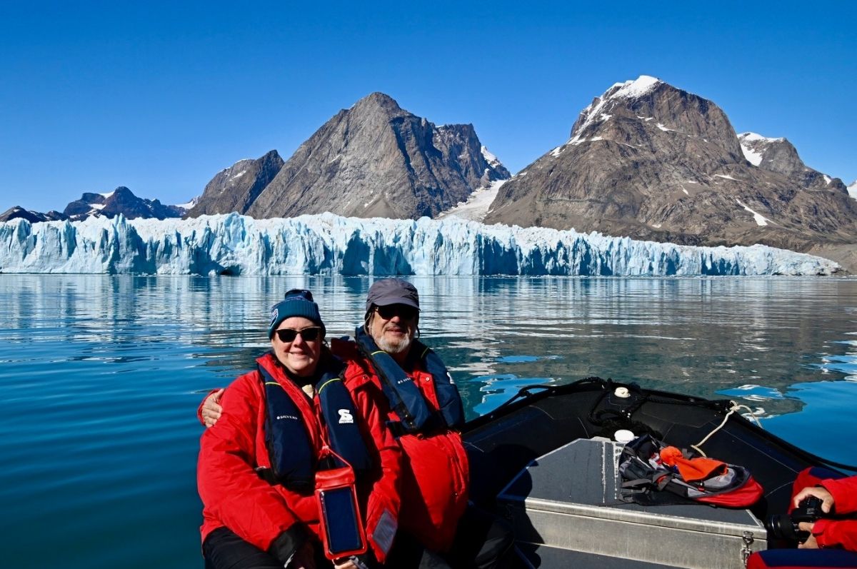Steve and Maureen Wincor on a boat in front of a large glacier shelf